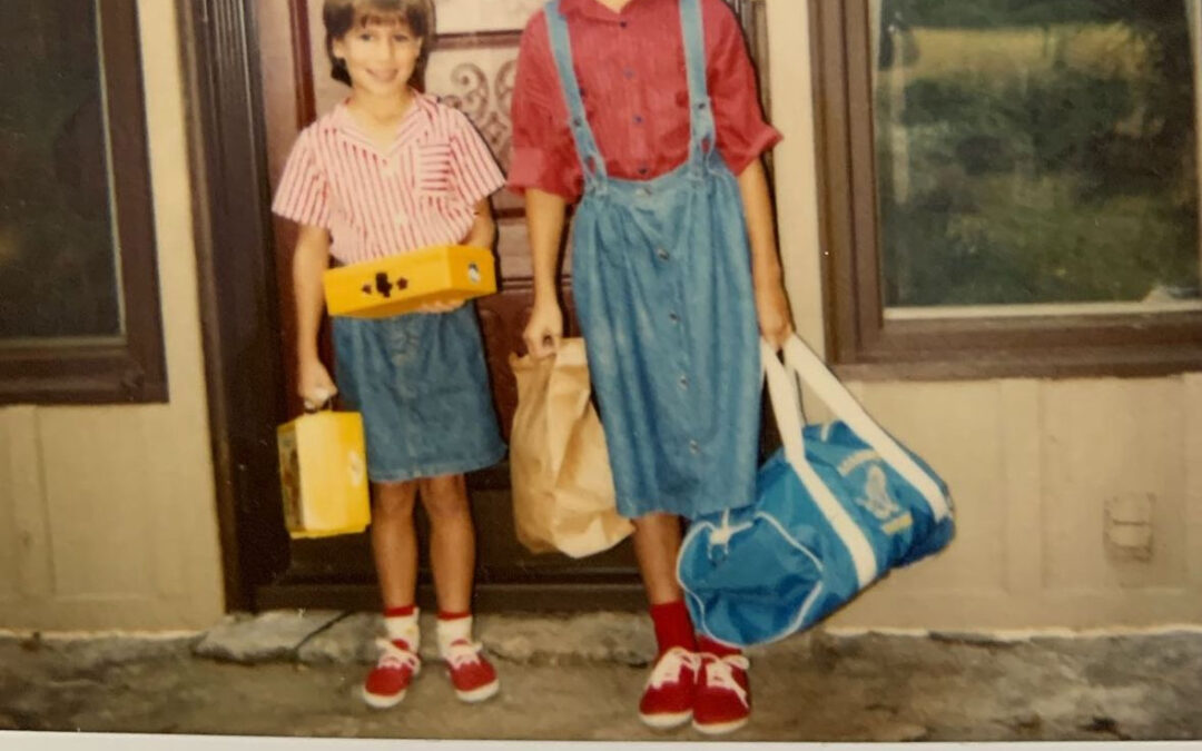 2 girls dressed for back to school with permed hair and glasses